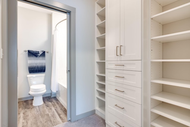 bathroom featuring toilet and hardwood / wood-style flooring