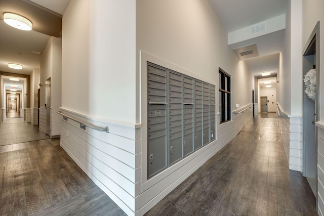 hallway featuring a mail area and dark hardwood / wood-style floors