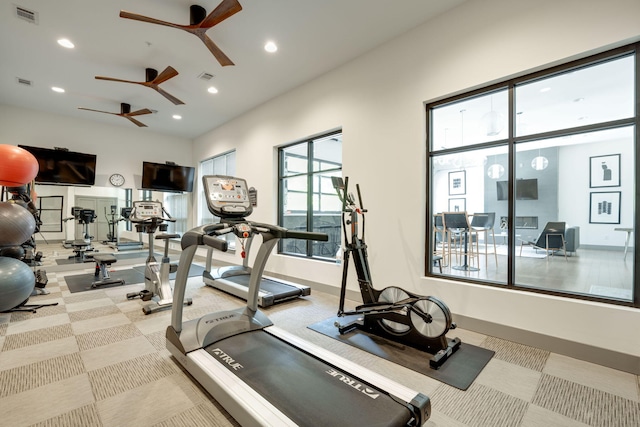 gym featuring light colored carpet and ceiling fan