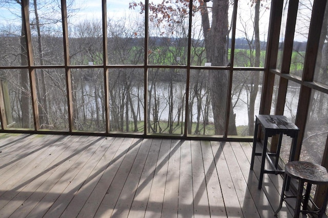 wooden terrace featuring a water view