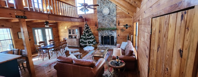 living room with high vaulted ceiling, ceiling fan, and a wealth of natural light