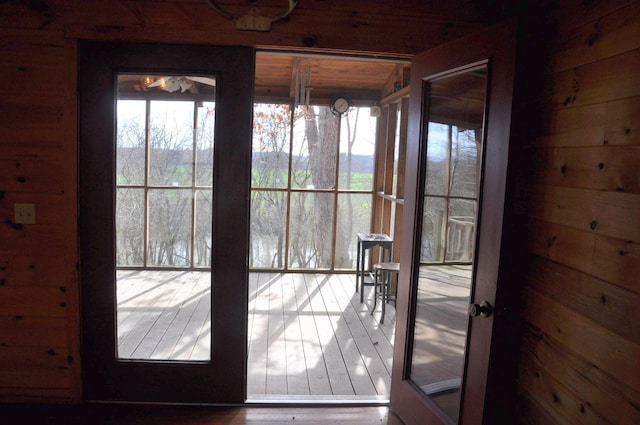 entryway featuring hardwood / wood-style floors and wood walls