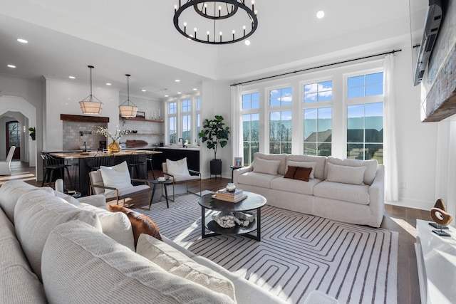 living room with a mountain view, a notable chandelier, and wood-type flooring