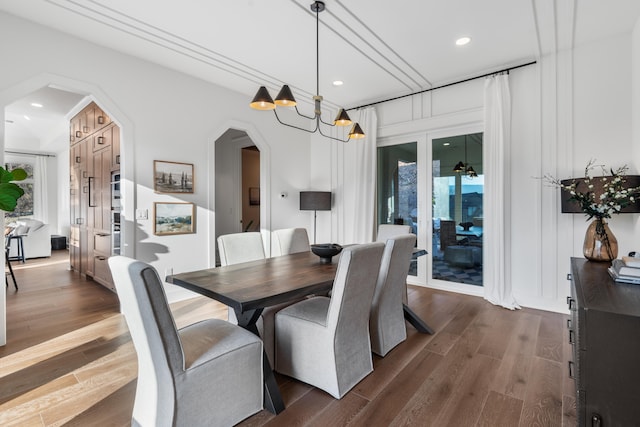 dining room featuring a notable chandelier and dark hardwood / wood-style floors