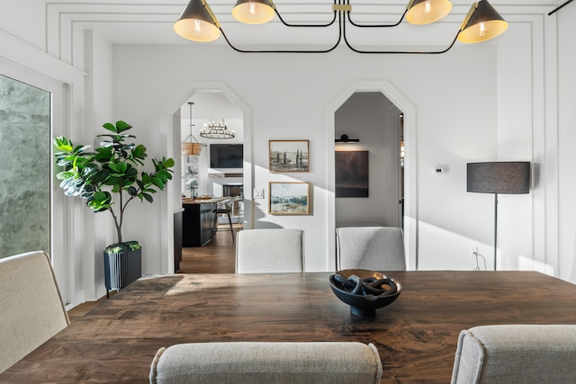 dining area featuring dark wood-type flooring and a chandelier