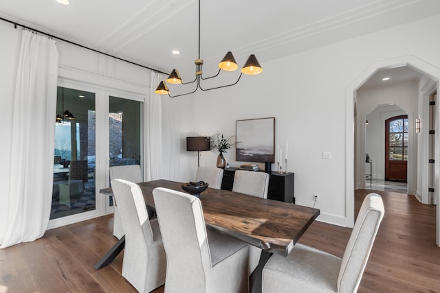 dining area with hardwood / wood-style flooring and a chandelier