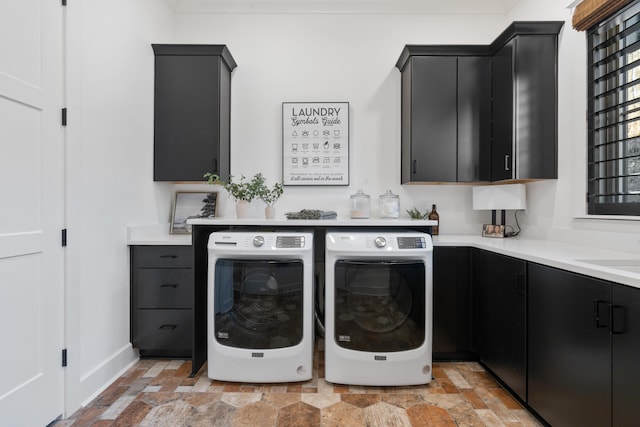 laundry area with cabinets, washer and clothes dryer, and sink