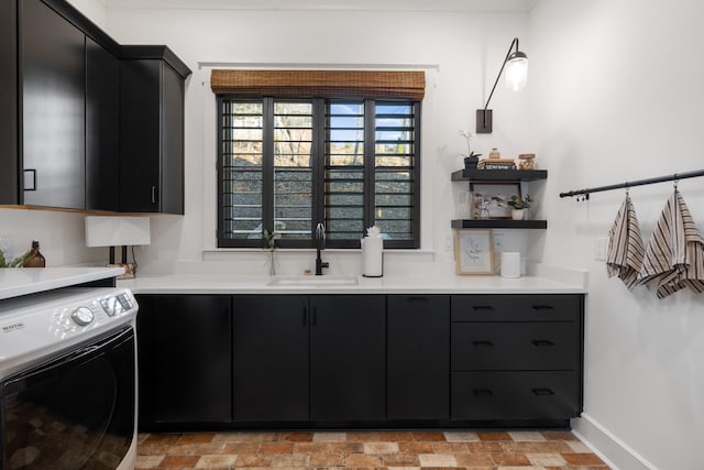 kitchen with washer / dryer and sink