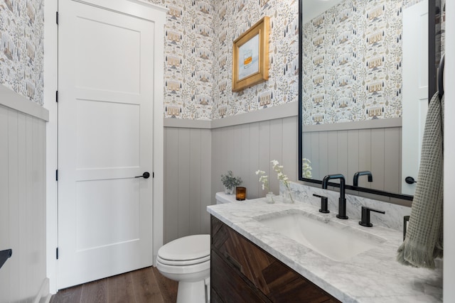 bathroom with vanity, toilet, and hardwood / wood-style floors