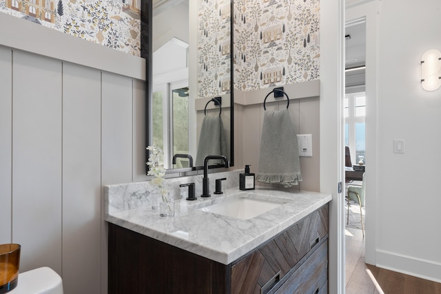 bathroom with vanity, toilet, and hardwood / wood-style floors