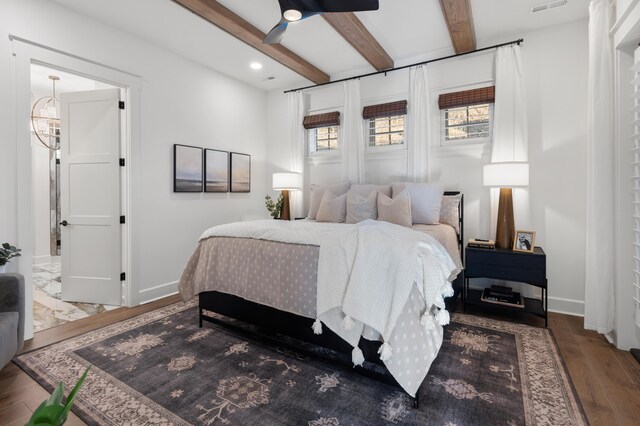 bedroom with wood-type flooring, beam ceiling, and ceiling fan