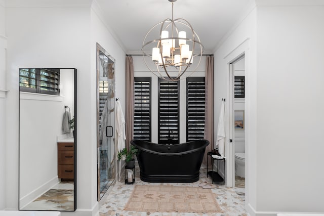 bathroom featuring an inviting chandelier, toilet, a bathing tub, ornamental molding, and vanity