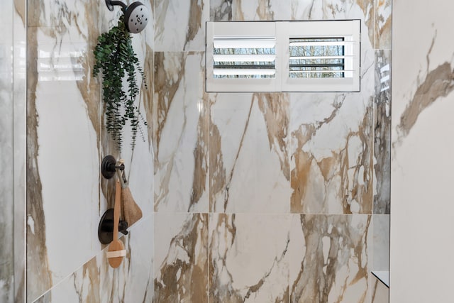 interior details featuring a tile shower