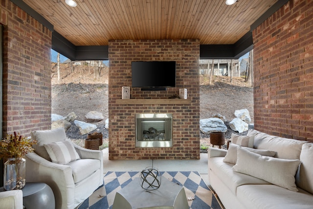 unfurnished living room featuring a wealth of natural light, brick wall, and wooden ceiling