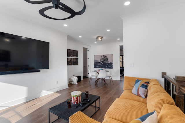 living room with ceiling fan, ornamental molding, and dark hardwood / wood-style flooring