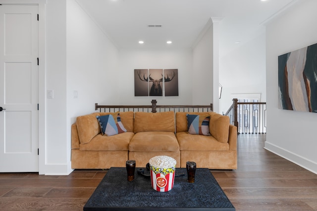 living room with dark hardwood / wood-style floors and crown molding