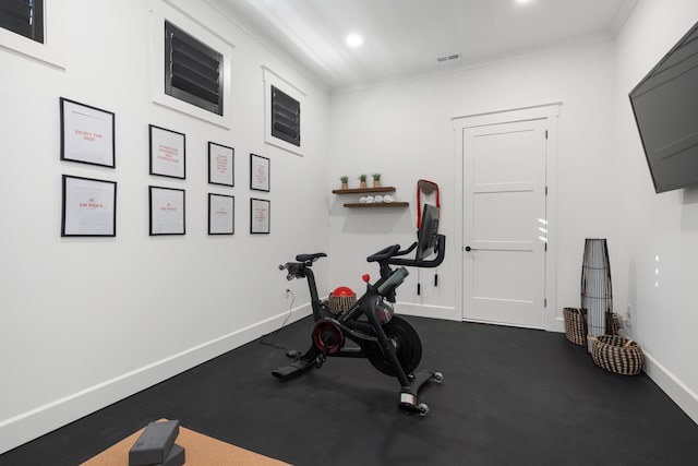 workout area featuring ornamental molding