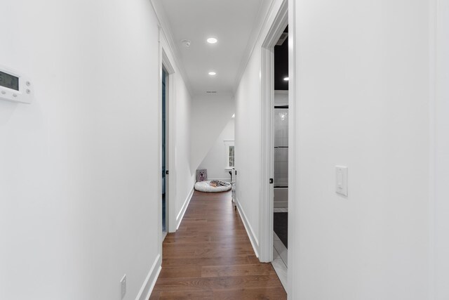 hallway featuring crown molding and wood-type flooring