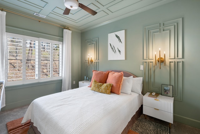 bedroom with crown molding, ceiling fan, and dark colored carpet