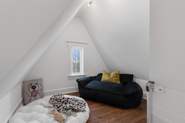 sitting room featuring vaulted ceiling and dark hardwood / wood-style flooring