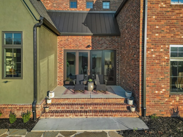 doorway to property with a patio area