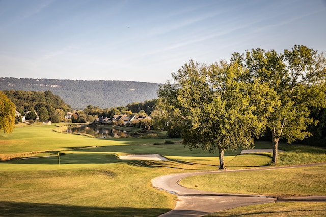 surrounding community featuring a lawn and a mountain view