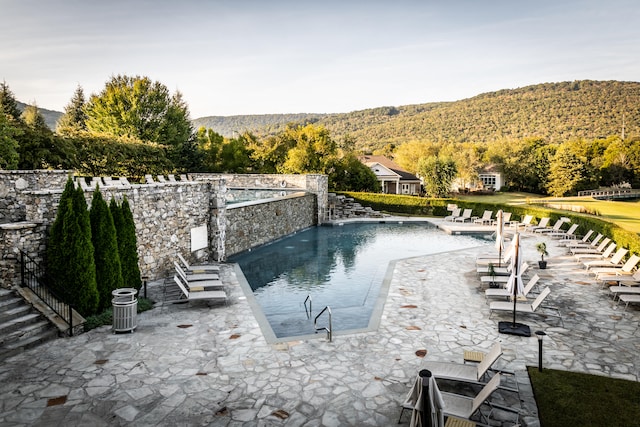 view of swimming pool featuring a mountain view, a patio, and pool water feature