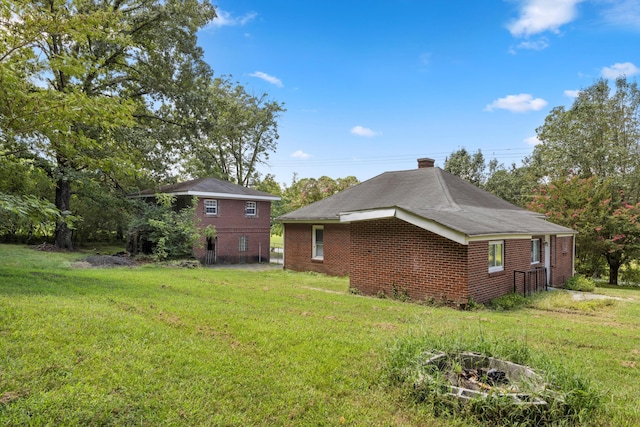 view of side of property with a lawn and brick siding