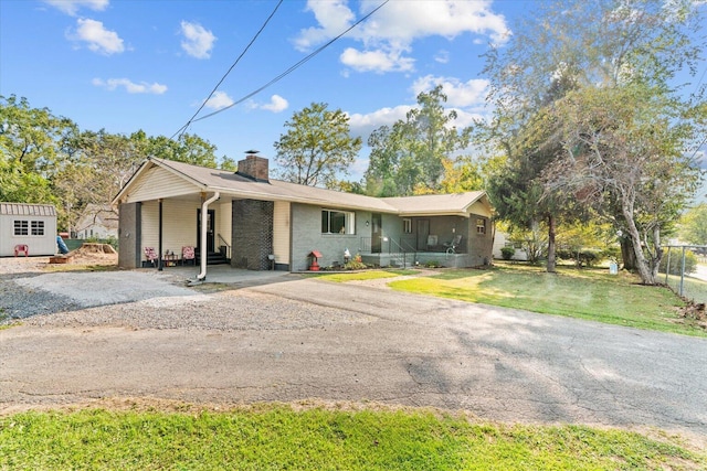 ranch-style house with a carport and a shed