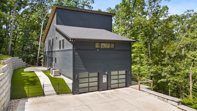 exterior space featuring a garage and central AC unit