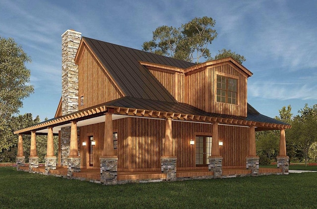 exterior space with metal roof, a front yard, and a chimney