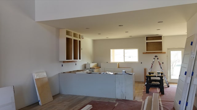 kitchen featuring wood finished floors and a healthy amount of sunlight