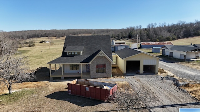 view of front of home featuring a garage and a shingled roof