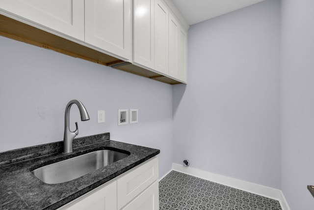 laundry room with washer hookup, tile patterned floors, cabinets, and sink