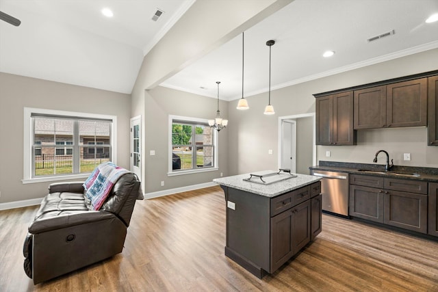 kitchen with plenty of natural light, dishwasher, vaulted ceiling, and sink