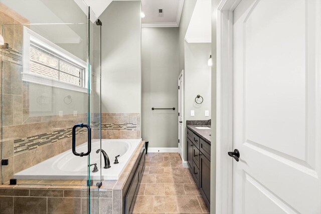 bathroom featuring ornamental molding, tiled bath, and vanity