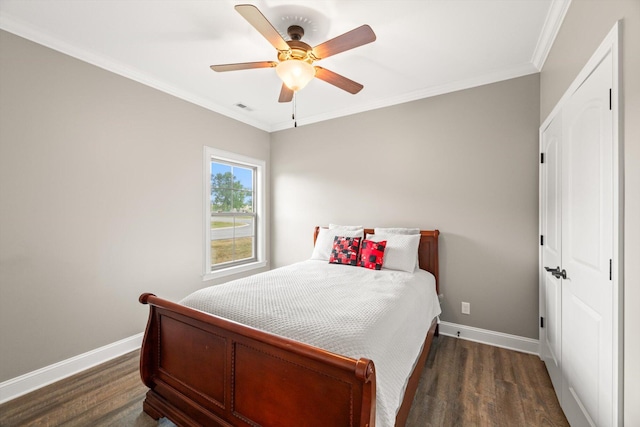 bedroom featuring ceiling fan, dark hardwood / wood-style flooring, and ornamental molding