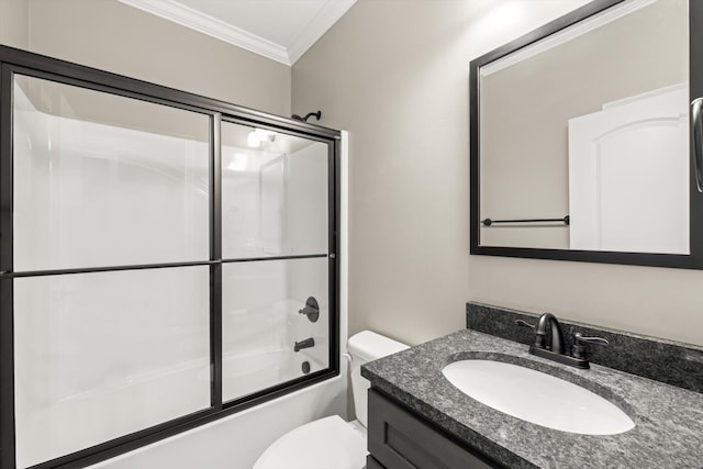 bathroom with toilet, vanity, ornamental molding, and bath / shower combo with glass door