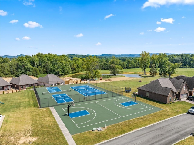 view of basketball court with a lawn and tennis court