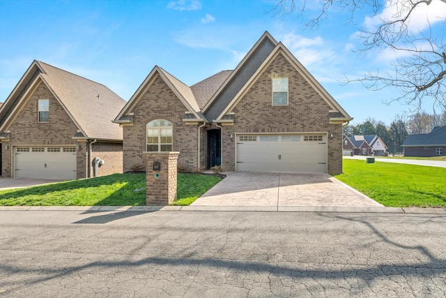 view of front of house featuring brick siding, driveway, an attached garage, and a front lawn