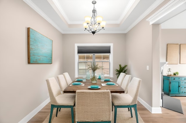 207 Zion Cove Ln, Englewood, TN 37329 - dining room featuring a chandelier, light wood-style flooring, baseboards, a raised ceiling, and crown molding