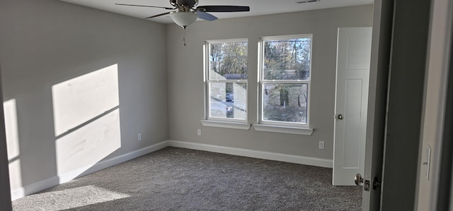 empty room with carpet, visible vents, ceiling fan, and baseboards