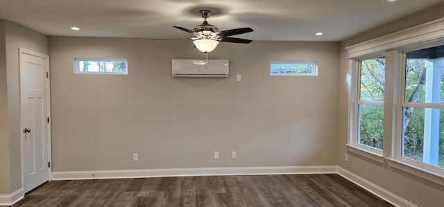 unfurnished room with a wall mounted air conditioner, ceiling fan, and dark wood-type flooring