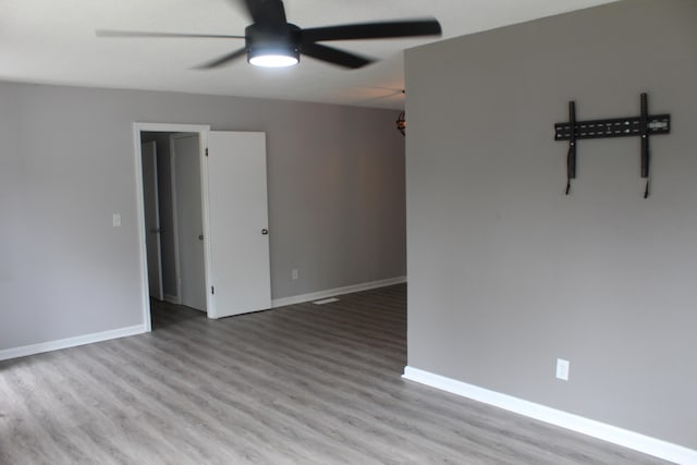 spare room with light hardwood / wood-style flooring and ceiling fan