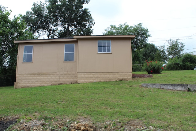 view of side of home featuring a yard