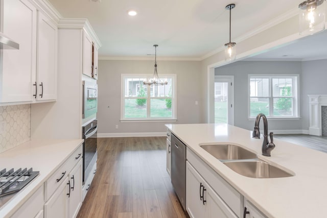 kitchen featuring sink, light hardwood / wood-style flooring, white cabinetry, appliances with stainless steel finishes, and decorative backsplash