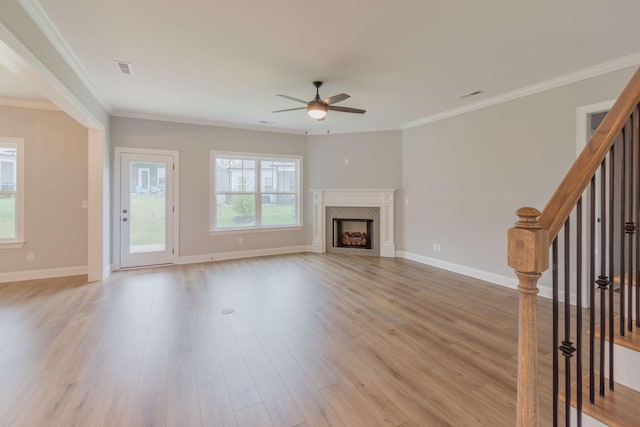 unfurnished living room featuring ceiling fan, light wood-type flooring, and ornamental molding