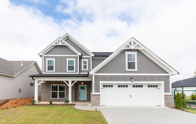 craftsman house featuring a front yard, a garage, and a porch