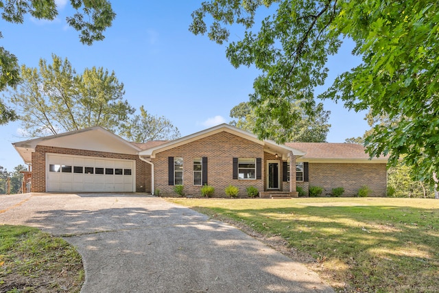 ranch-style house featuring a front lawn and a garage