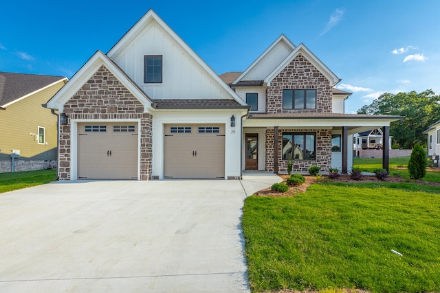 craftsman house featuring covered porch, a front yard, and a garage